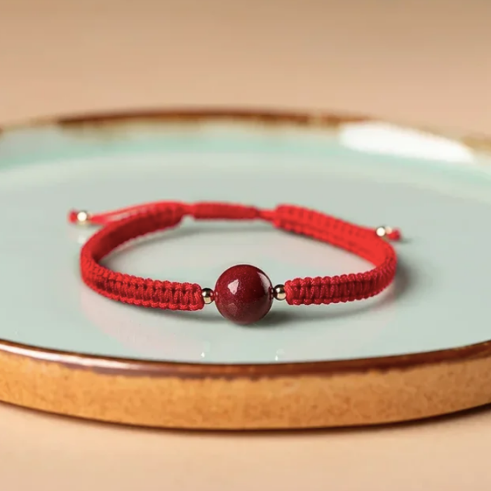 ARMBAND - RODE DRAAD VAN HET LOT
