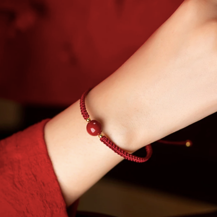 ARMBAND - RODE DRAAD VAN HET LOT