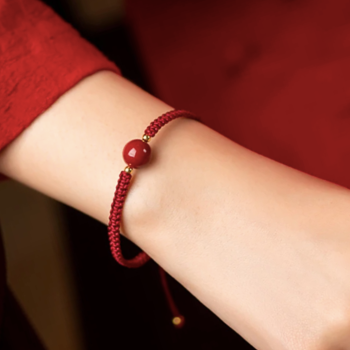 ARMBAND - RODE DRAAD VAN HET LOT