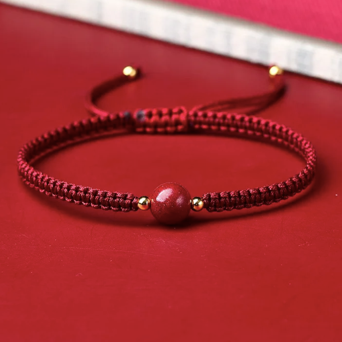 ARMBAND - RODE DRAAD VAN HET LOT